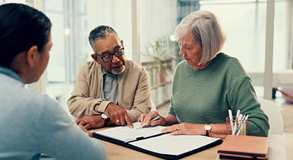 Two older people looking at documents